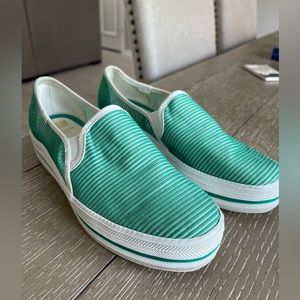 Kate Spade green slip on shoes.